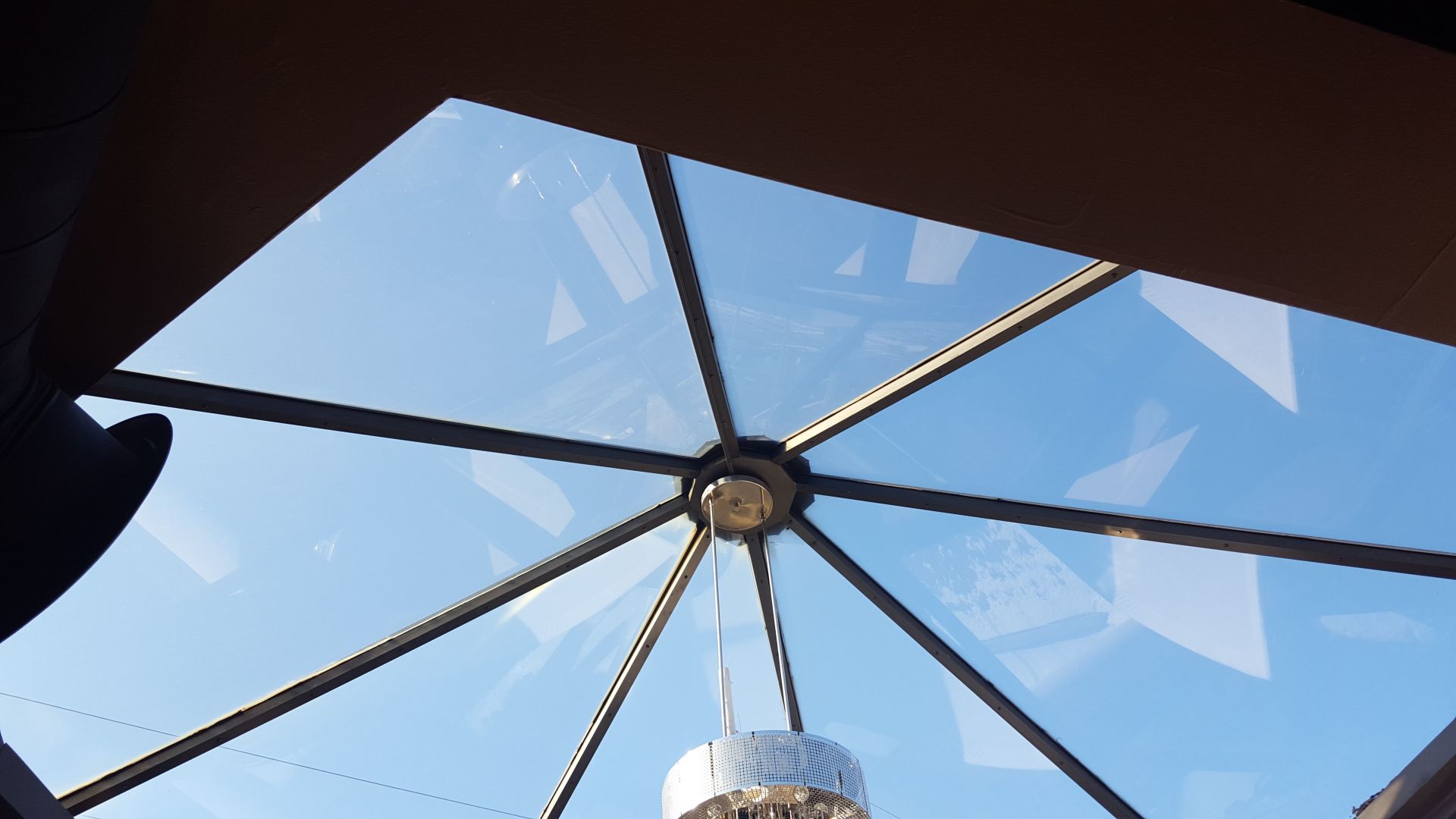 A disco ball is hanging from the ceiling of a building