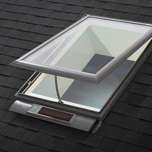 A skylight on a roof with the glass open