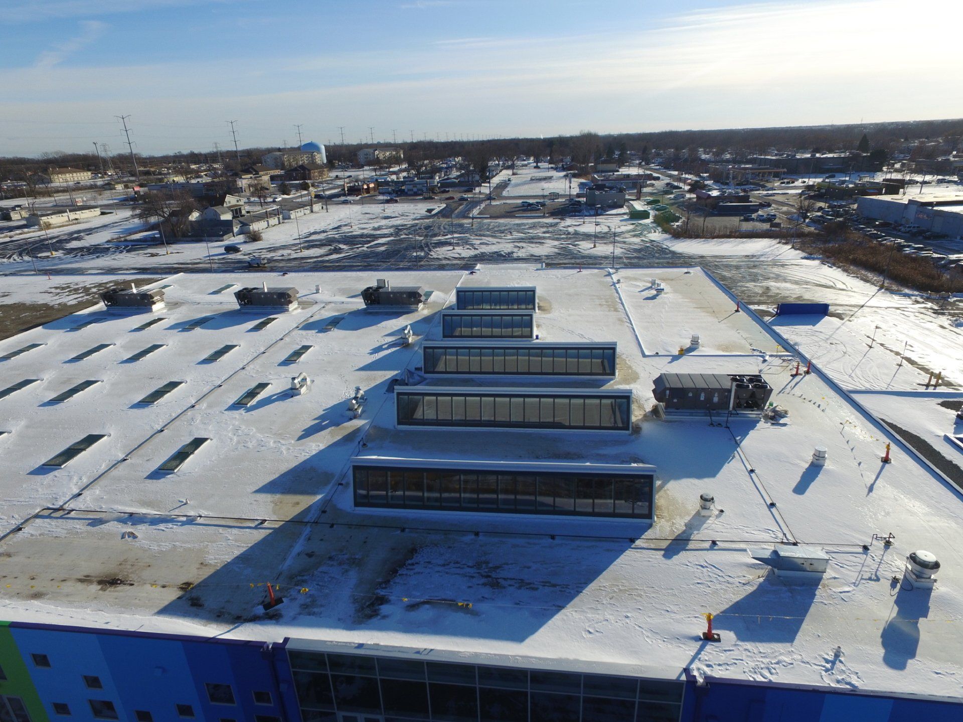 An aerial view of a snow covered roof of a building.