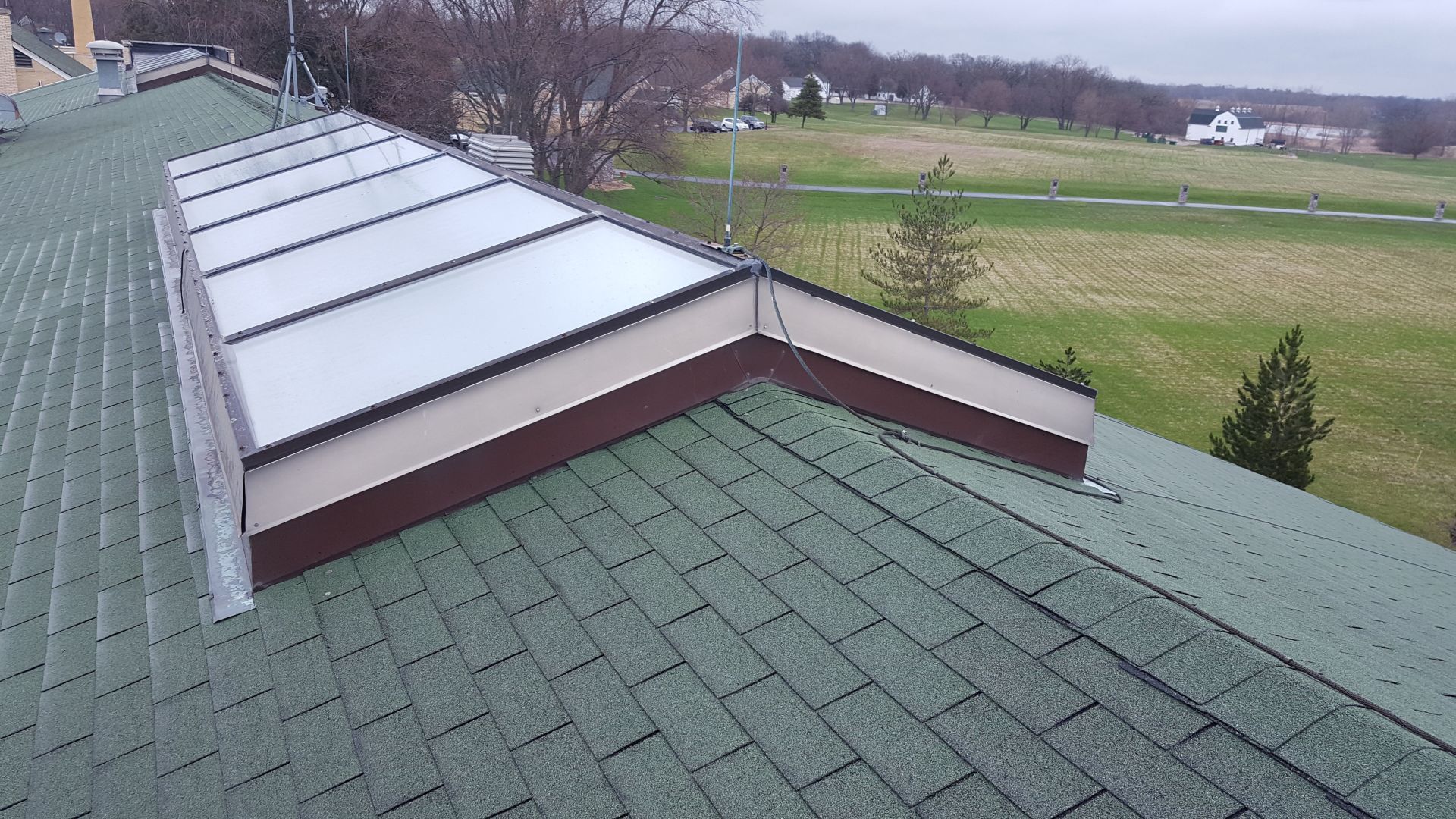 A green roof with a skylight on top of it