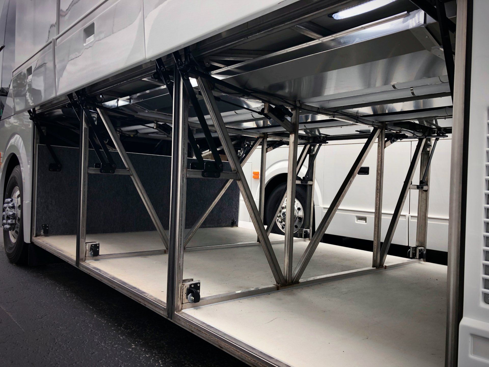 The underside of a bus with a stainless steel frame
