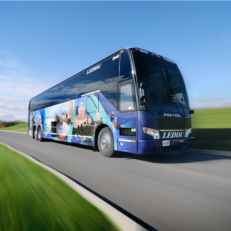 A blue lynx bus is driving down a road