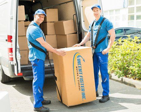 Moving — Two Workers Carrying A Huge Box In Lexington,KY Moving — Two Workers Carrying A Huge Box In Lexington,KY