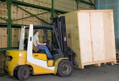 Moving — Worker Transporting A Huge Crate In Lexington,KY Moving — Worker Transporting A Huge Crate In Lexington,KY