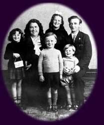 A black and white photo of a family posing for a picture.