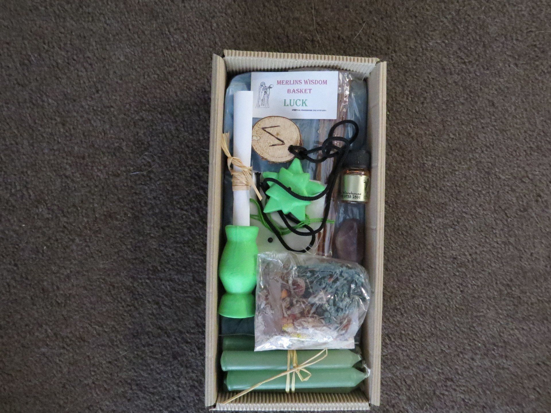 A cardboard box filled with candles and other items