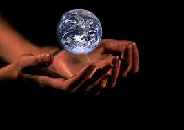 A person is holding a globe in their hands.