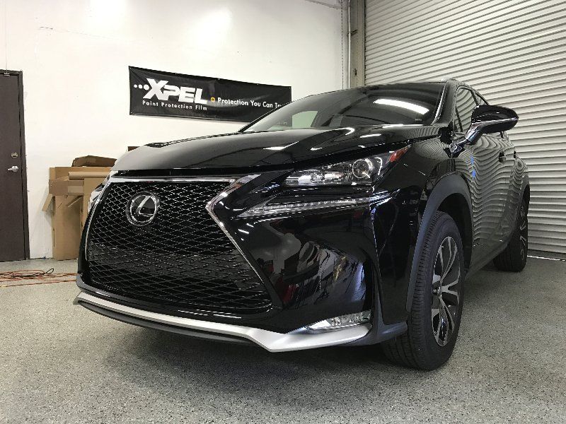 A black lexus nx is parked in a garage.