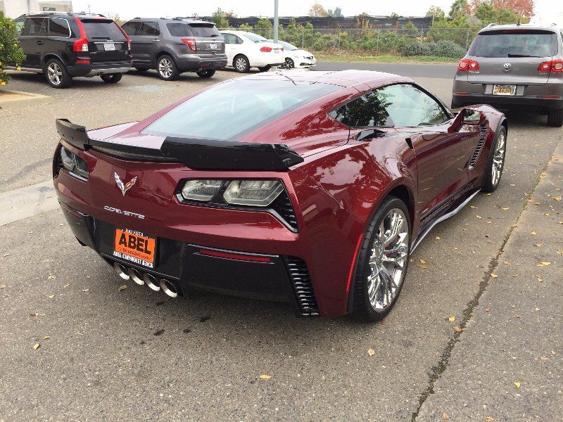 A red sports car with a license plate that says abell