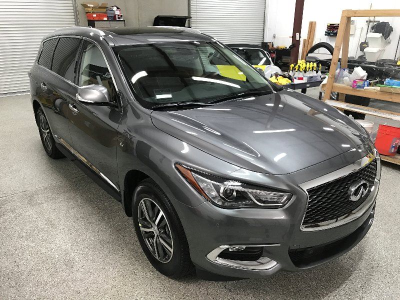 A gray suv is parked in a garage.