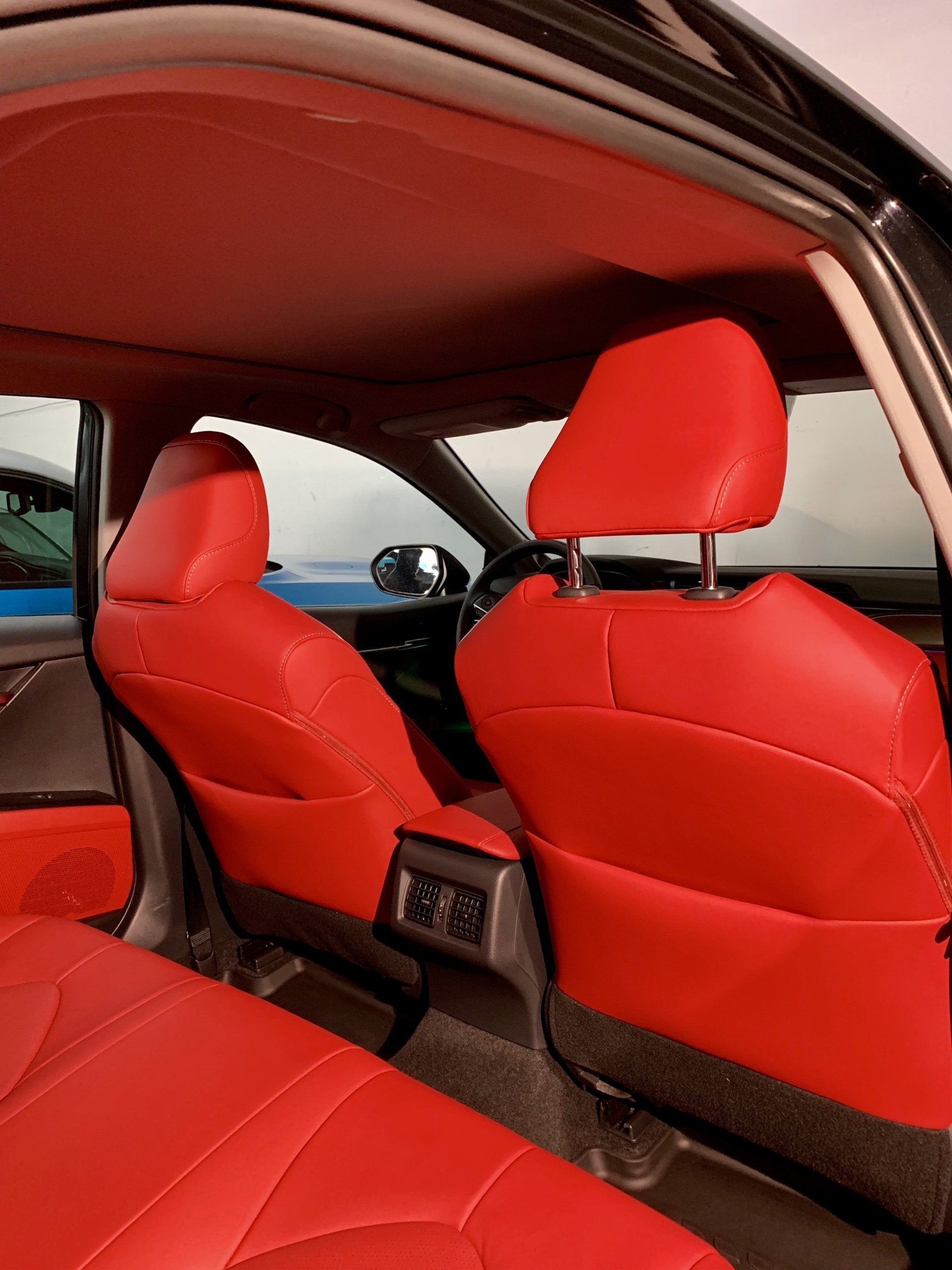 The interior of a black car with red seats