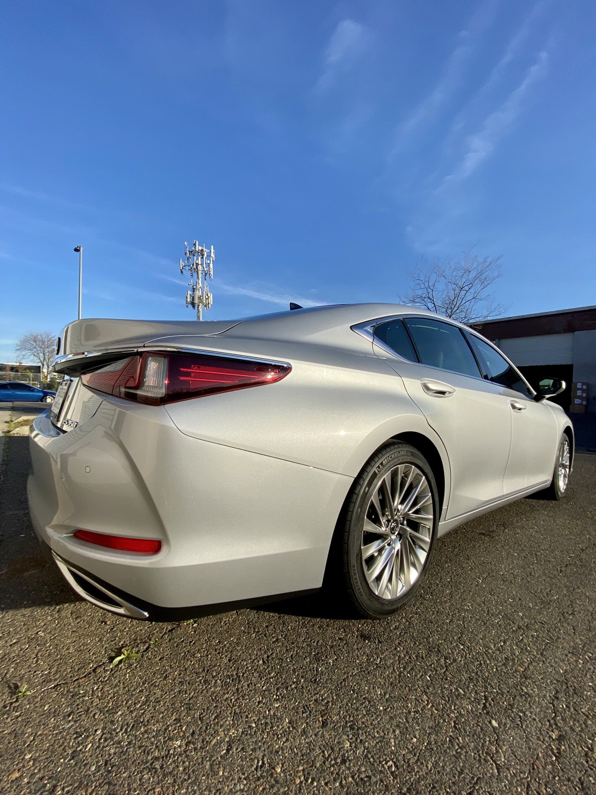 A white car is parked on the side of the road.