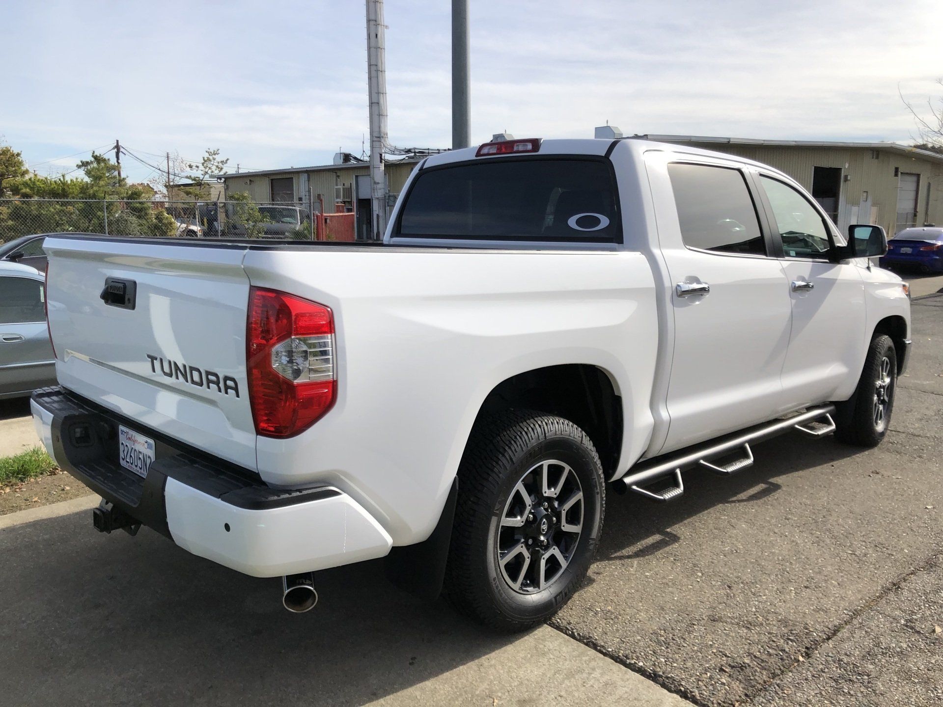 A white toyota tundra truck is parked on the side of the road.