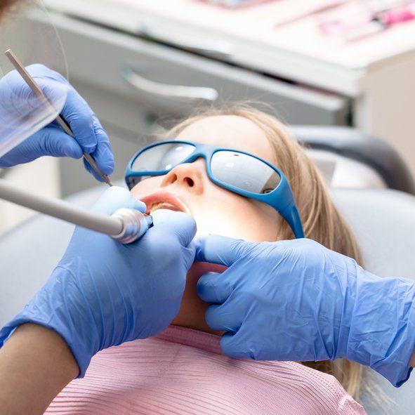 Little Girl Receiving Dental Procedure — Bloomingdale, IL — Dr Boyer & Scheive, DDS Little Girl Receiving Dental Procedure — Bloomingdale, IL — Dr Boyer & Scheive, DDS