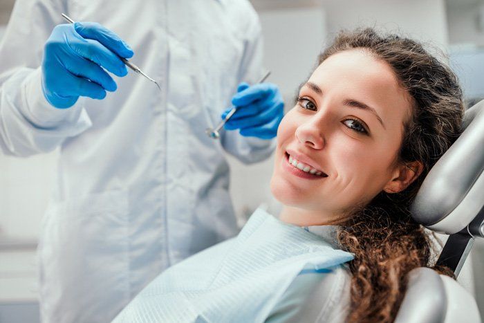 Smiling Young Woman Receiving Dental Checkup — Bloomingdale, IL — Dr Boyer & Scheive, DDS