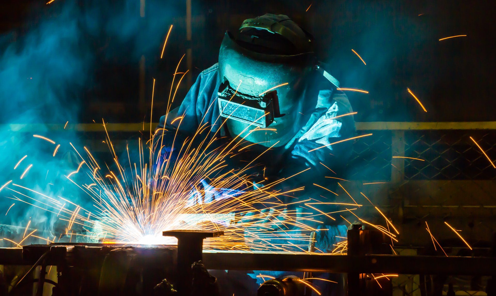 A Man is Welding a Piece of Metal in a Factory — Kymar Steel Fabrications in Teralba, NSW