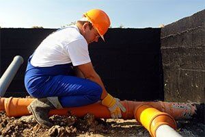 Plumber at work — Drain Cleaning Services in Michigan Plumber at work — Drain Cleaning Services in Michigan