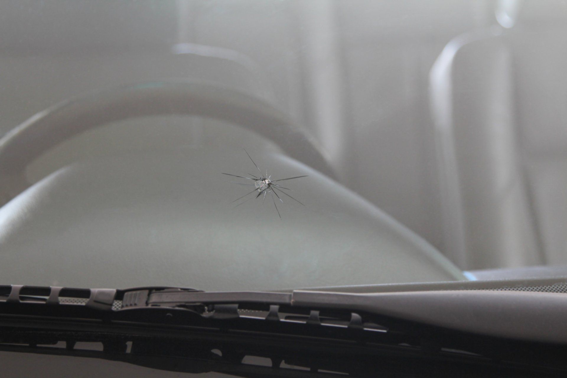Windshield Replacement — Damaged Car front windshield with Cracks caused by Splashing Debris in Rancho Cordova, CA Windshield Replacement — Damaged Car front windshield with Cracks caused by Splashing Debris in Rancho Cordova, CA