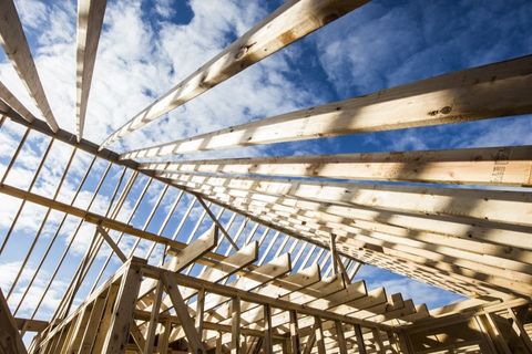 Framed house under construction with lumber.