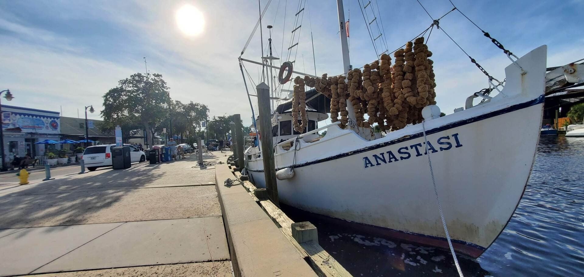 A boat named anastasi is docked at a dock.
