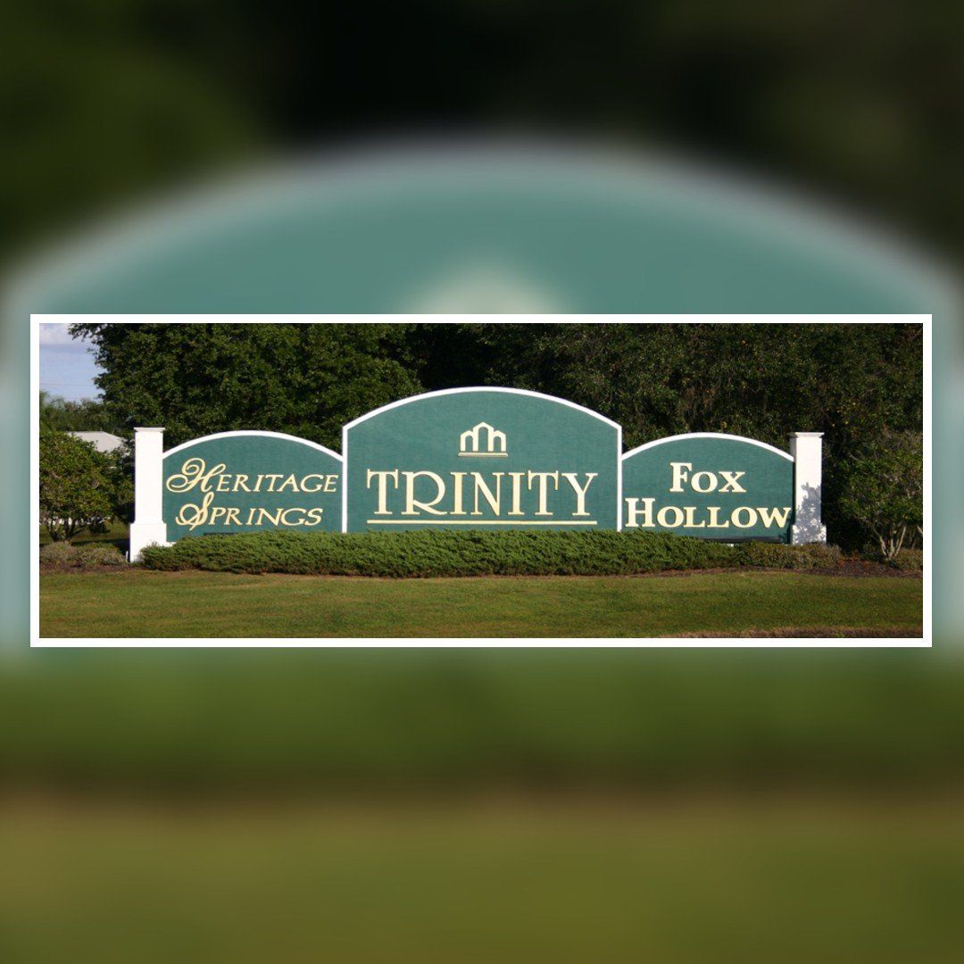 A sign that says trinity fox hollow on it
