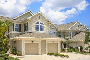 Neighborhood in the suburbs. Duplex homes garages and driveways.