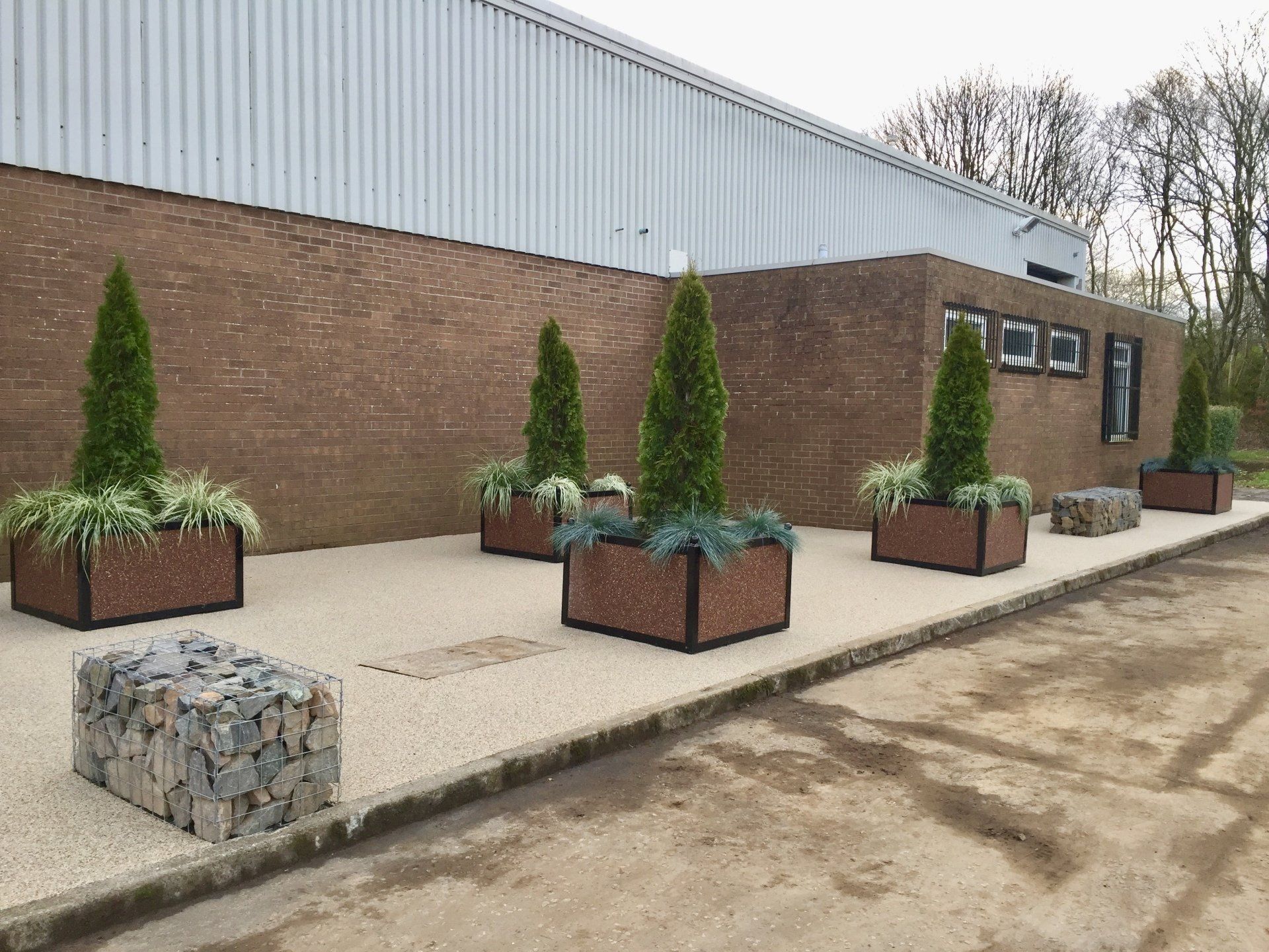 Low maintenance landscape with Azure Orange Planters