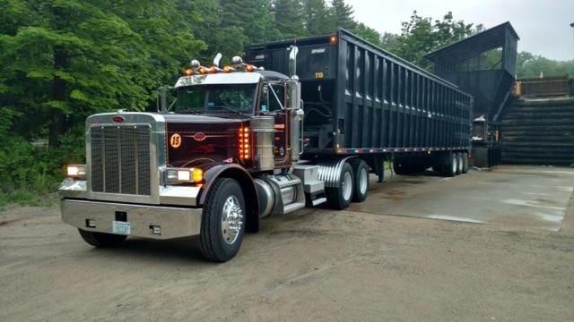 Dumpster — Dumpster Truck on Side View in Wilton, NH