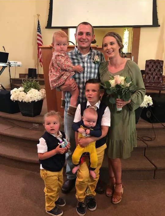 A family is posing for a picture in a church.