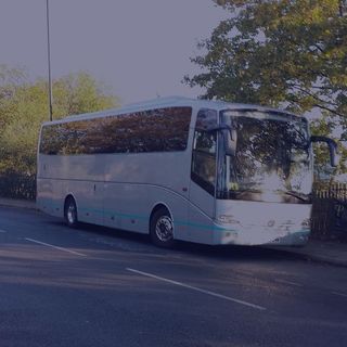 parked grey sb coaches vehicle