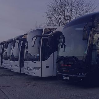 white and black vehicles aligned in a parking lot