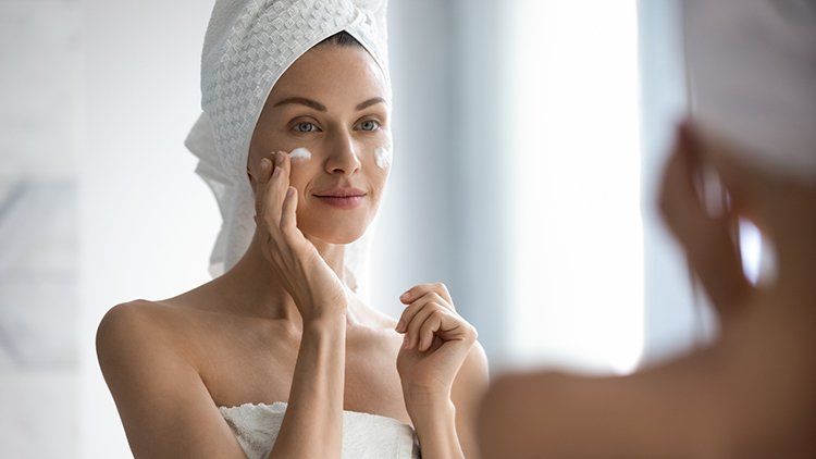 Young Woman Applying Facial Cream — Greenwood Village, CO — Beau Visage Skin Care & Spa