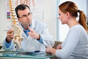 Doctor Explaining Chiropractic To Patient — Photo Therapy in Oshkosh, WI Doctor Explaining Chiropractic To Patient — Photo Therapy in Oshkosh, WI