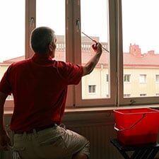 Man Wiping Windows — Butlers in Washington, PA Man Wiping Windows — Butlers in Washington, PA