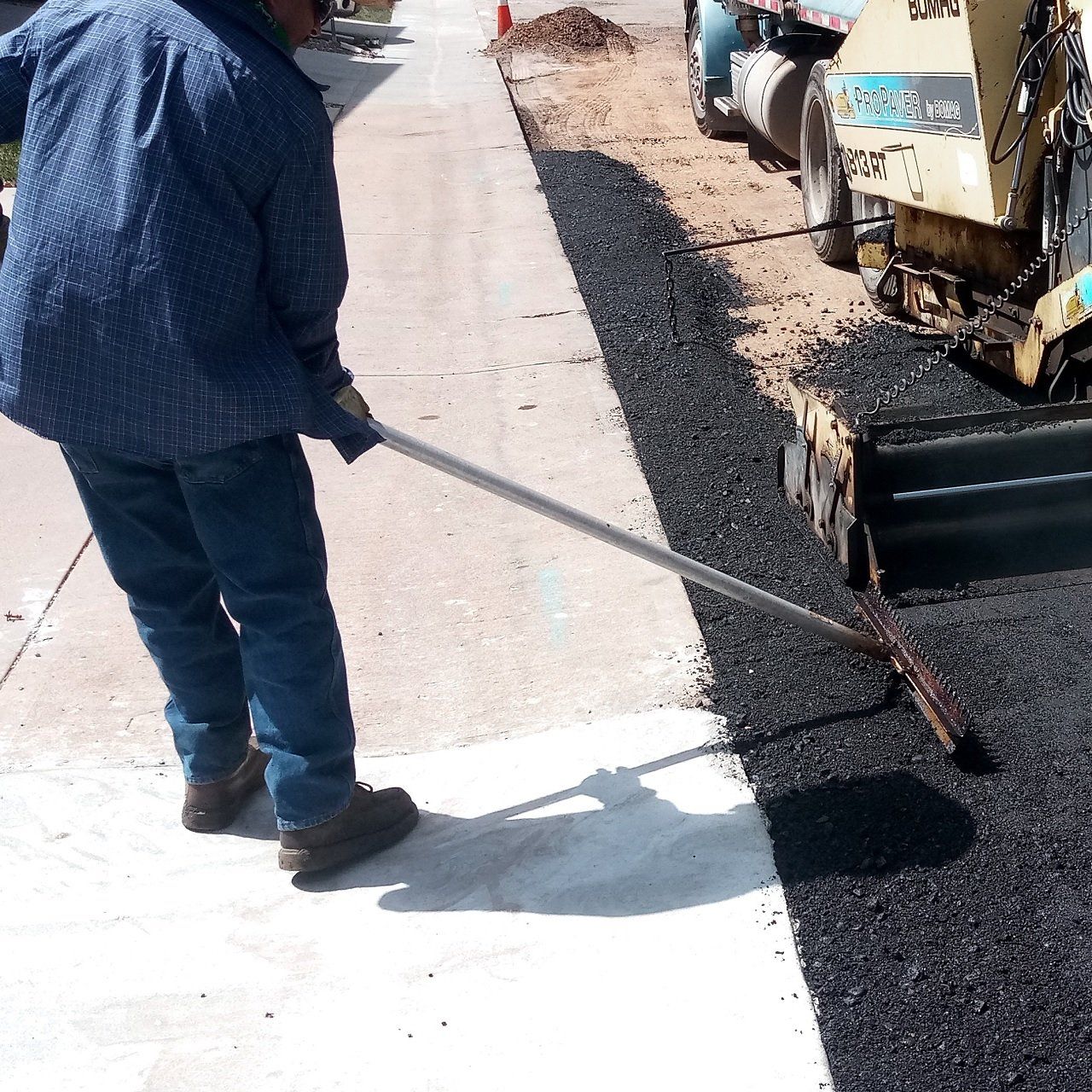 Asphalt is Unloaded from a Wheelbarrow — Wheat Ridge, CO — 5280 Asphalt Paving Contractors