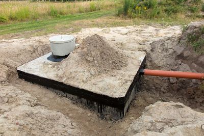 Septic Line Repair — Man Holding Hose For Cleaning Septic Tank in Lebanon, TN Septic Line Repair — Man Holding Hose For Cleaning Septic Tank in Lebanon, TN