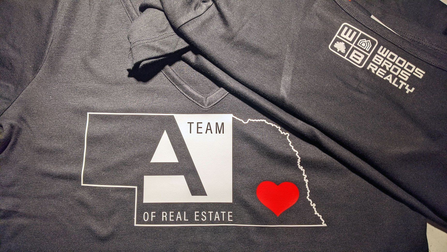 A team of real estate t-shirt with a heart on it