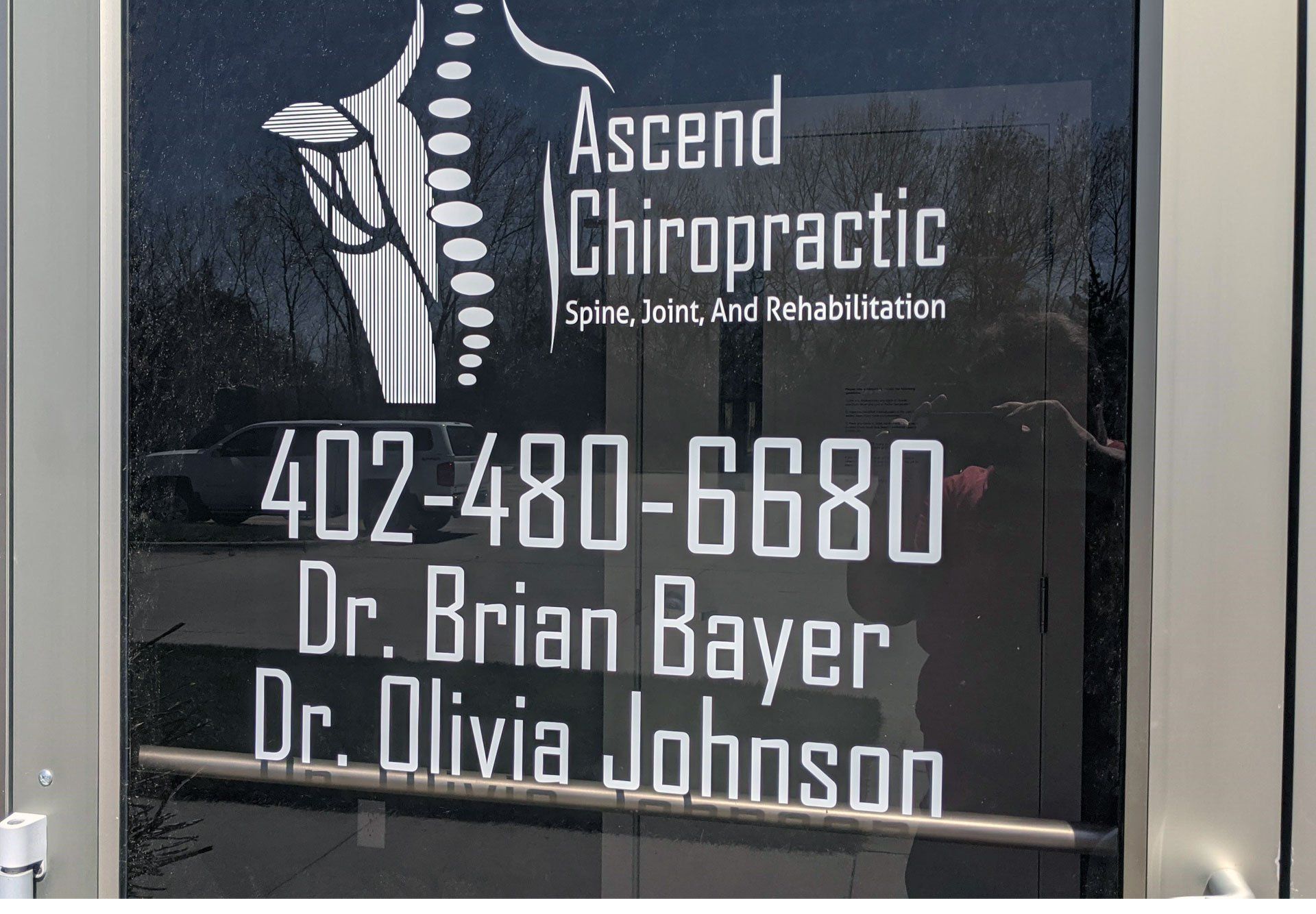 A door that says ascend chiropractic on it