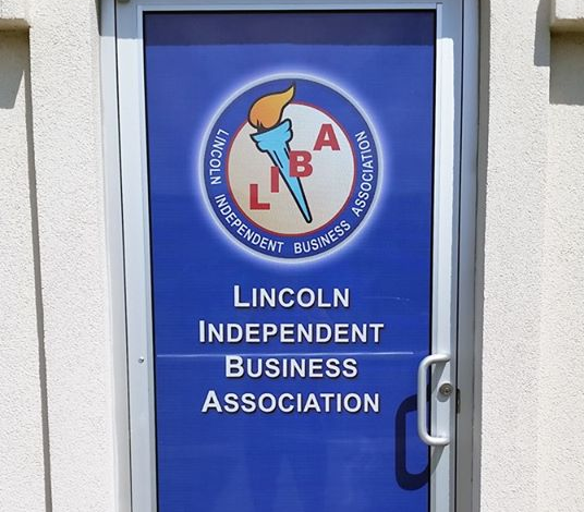 A blue door that says lincoln independent business association