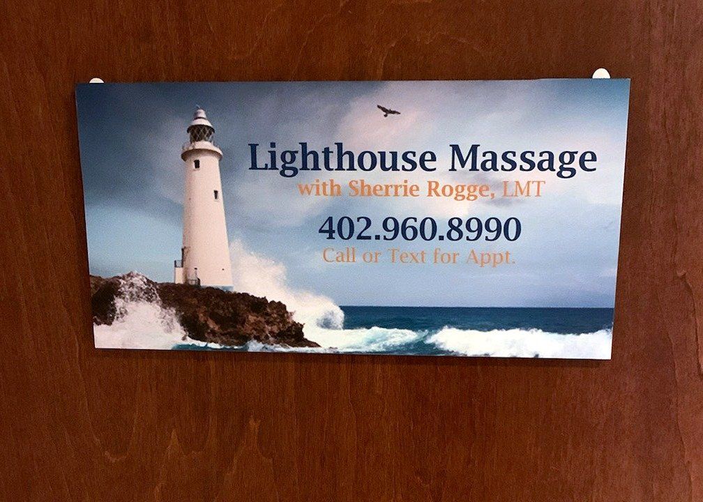 A sign that says lighthouse massage on it