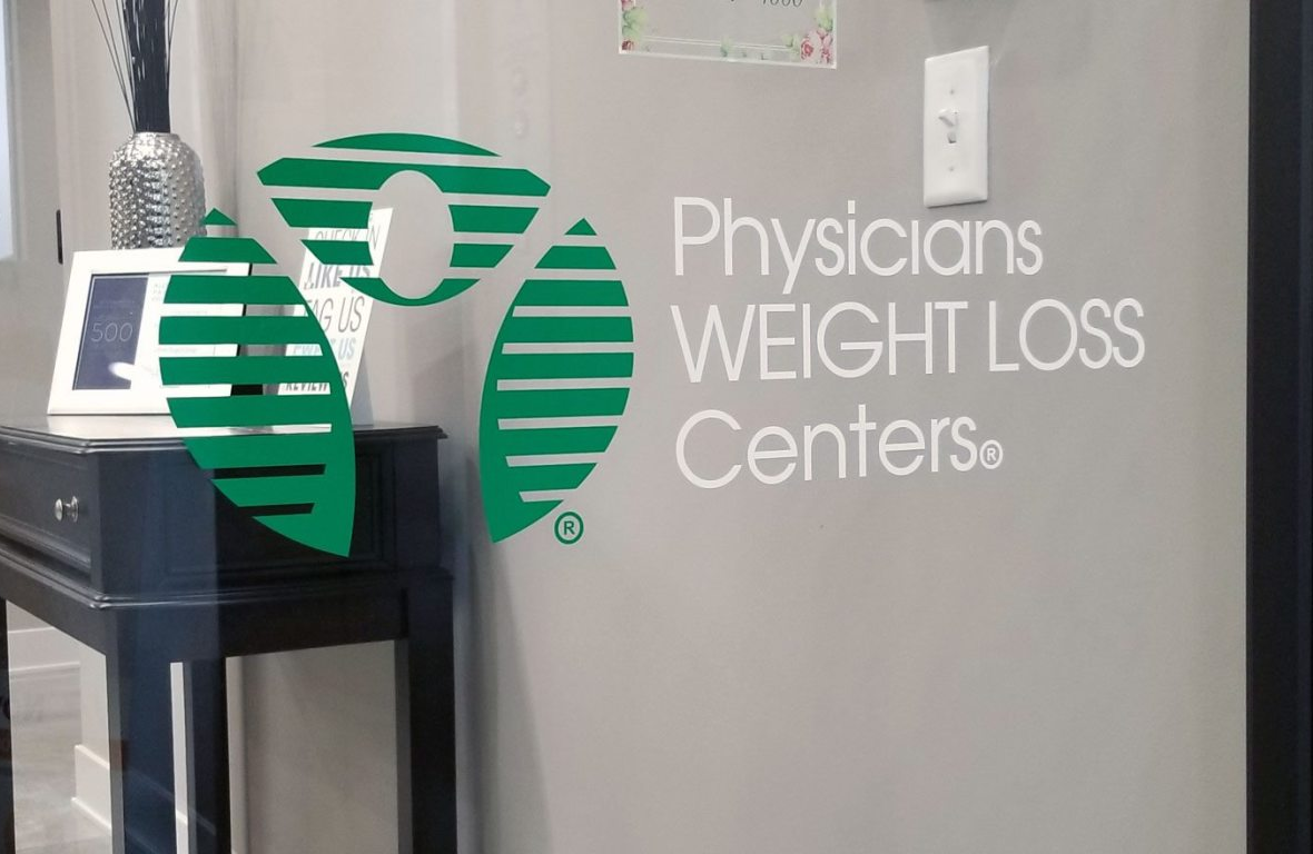 A sign on a wall that says physicians weight loss centers