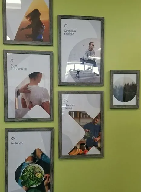 A group of framed pictures on a wall with one that says ' healthy ' on it