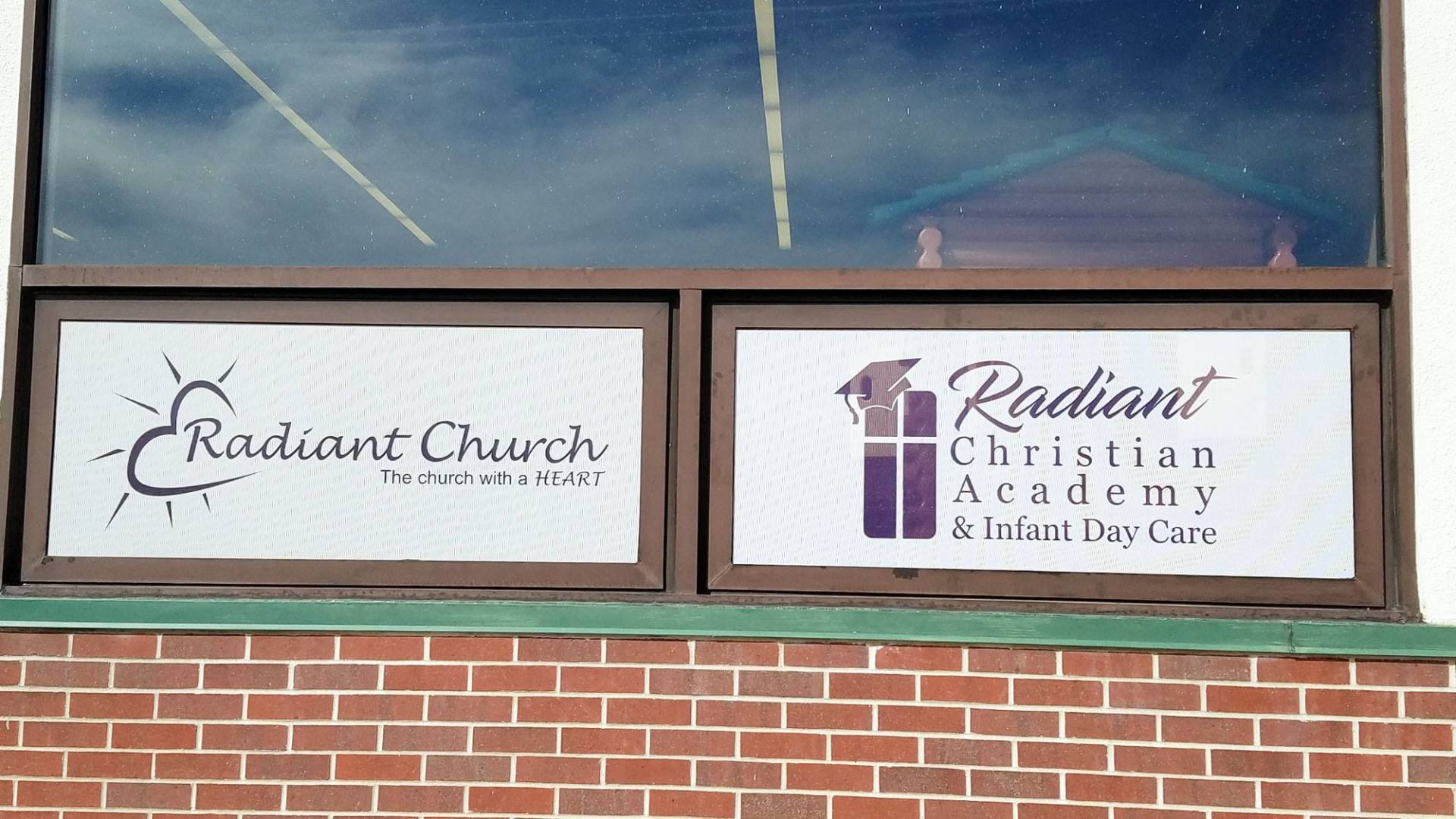A brick building with two windows that say radiant church and radiant christian academy