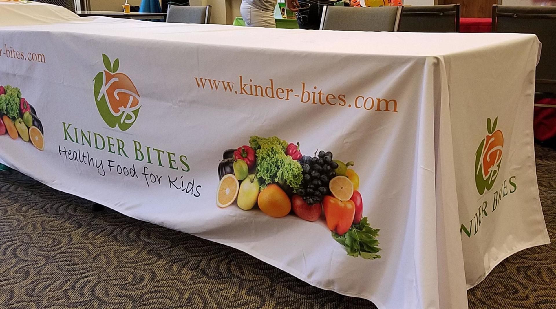 A table with a banner that says kinder bites on it