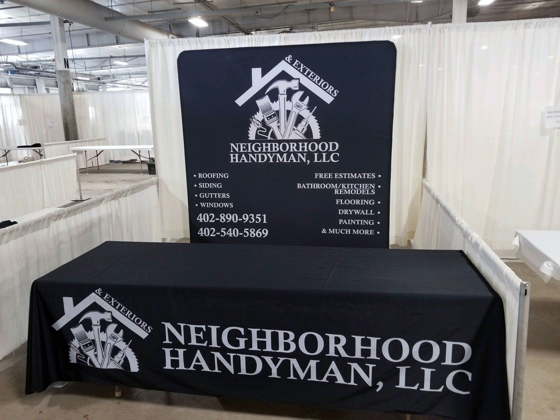 A black table cloth with neighborhood handyman llc written on it