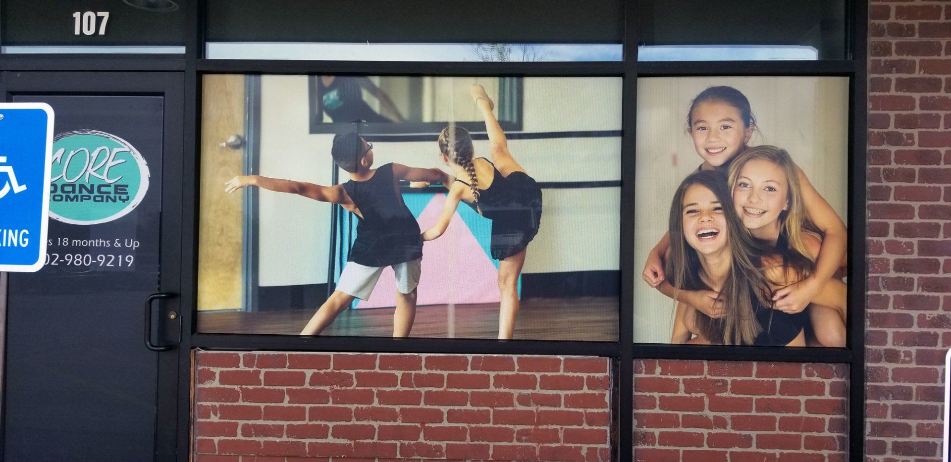 A group of young girls are dancing in a dance studio.