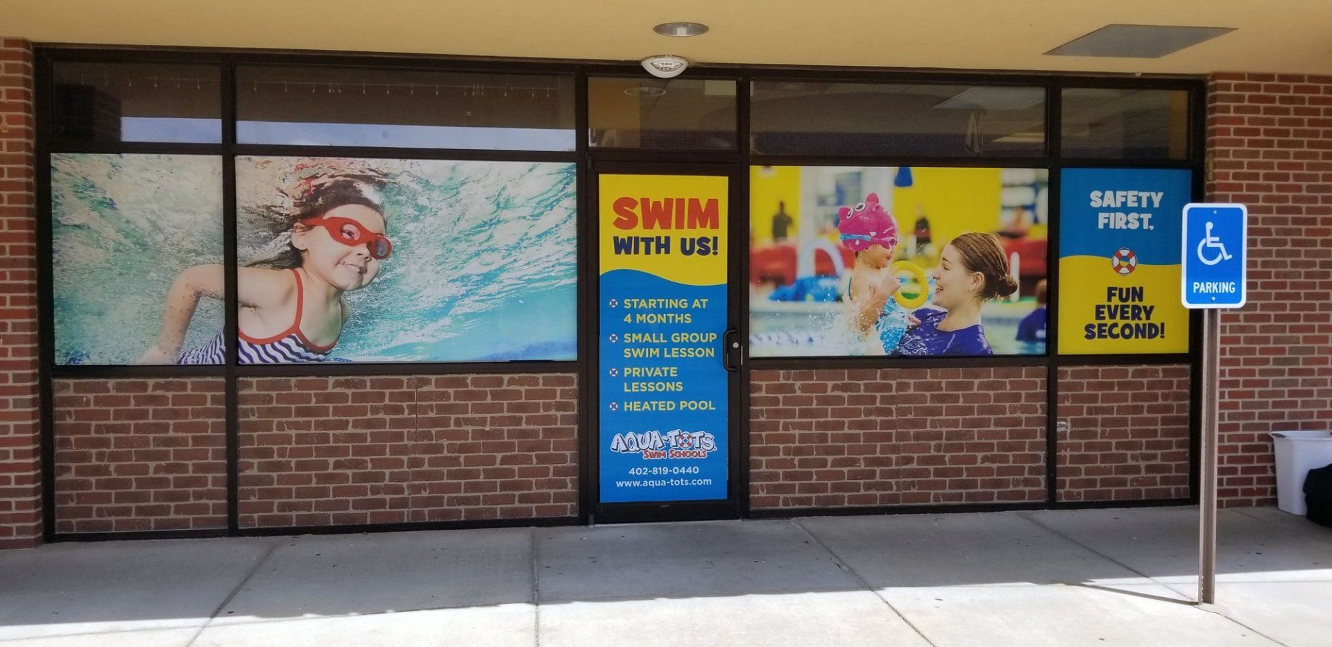 A brick building with a sign that says swim with us