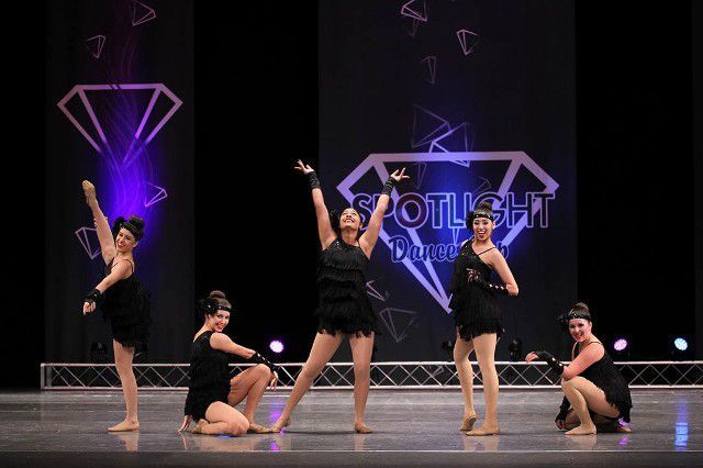 A group of young women are dancing on a stage.