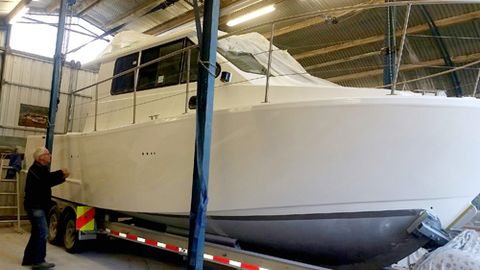 Professional examining the newly painted boat