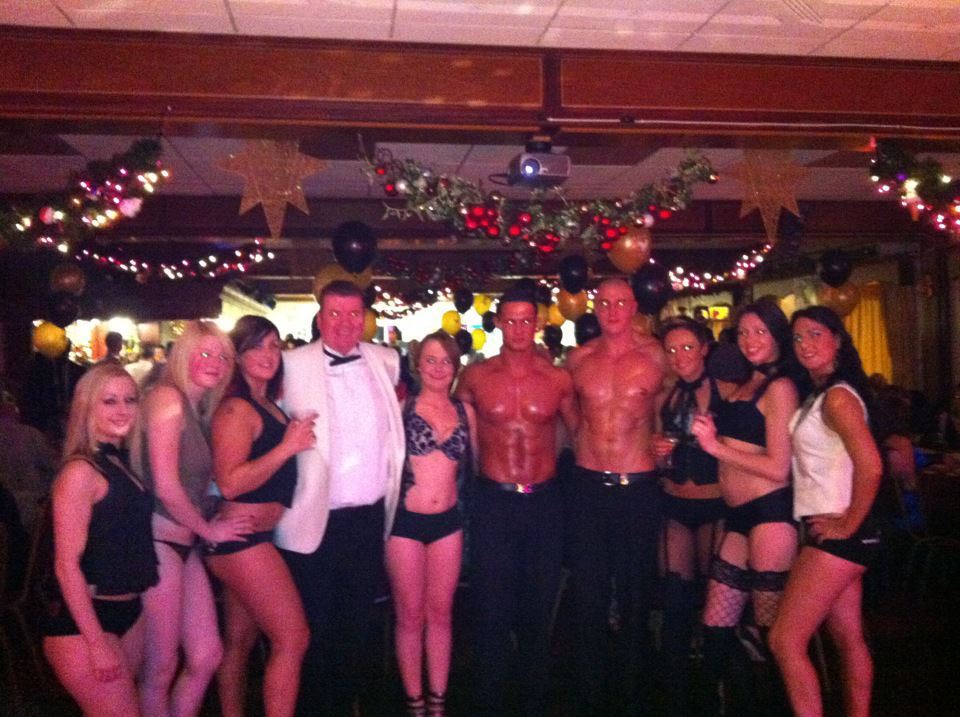 Group of promotional staff and entertainers posing together at an event, reflecting promo team hire options available for parties and corporate functions across the UK.